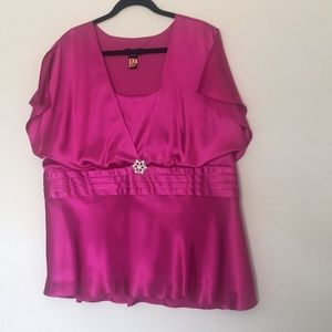 Bright pink blouse with silver brooch